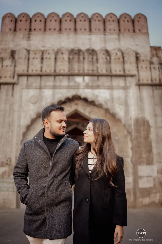 Couple smiling at each other during a relaxed pre-wedding shoot at a historic stone fort