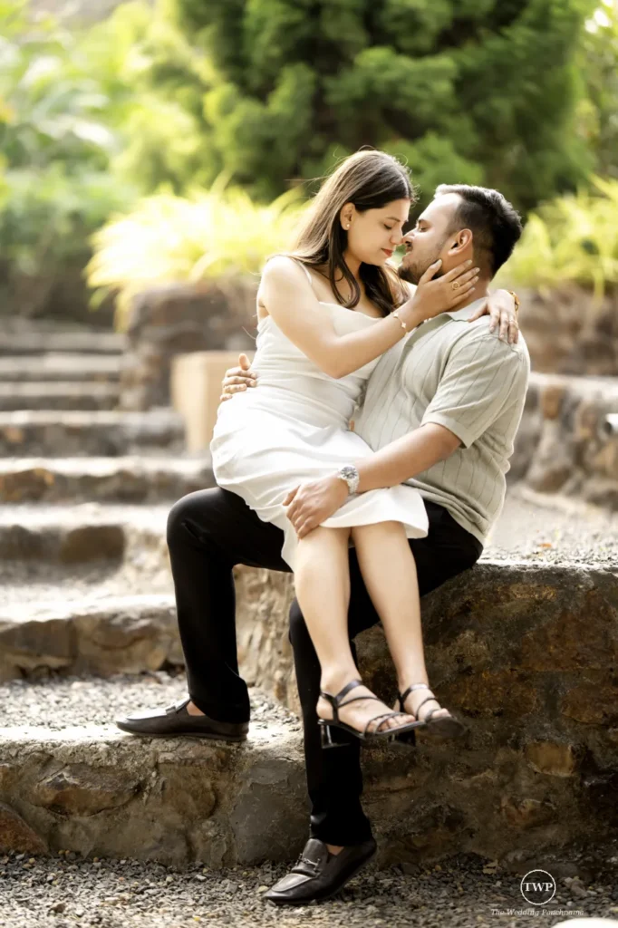 Couple sitting close on stone steps during a couple shoot near Indore