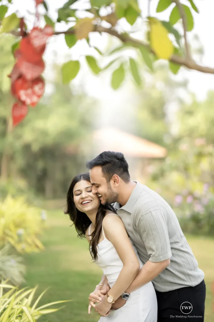 Couple laughing together in a garden during a couple shoot near Indore