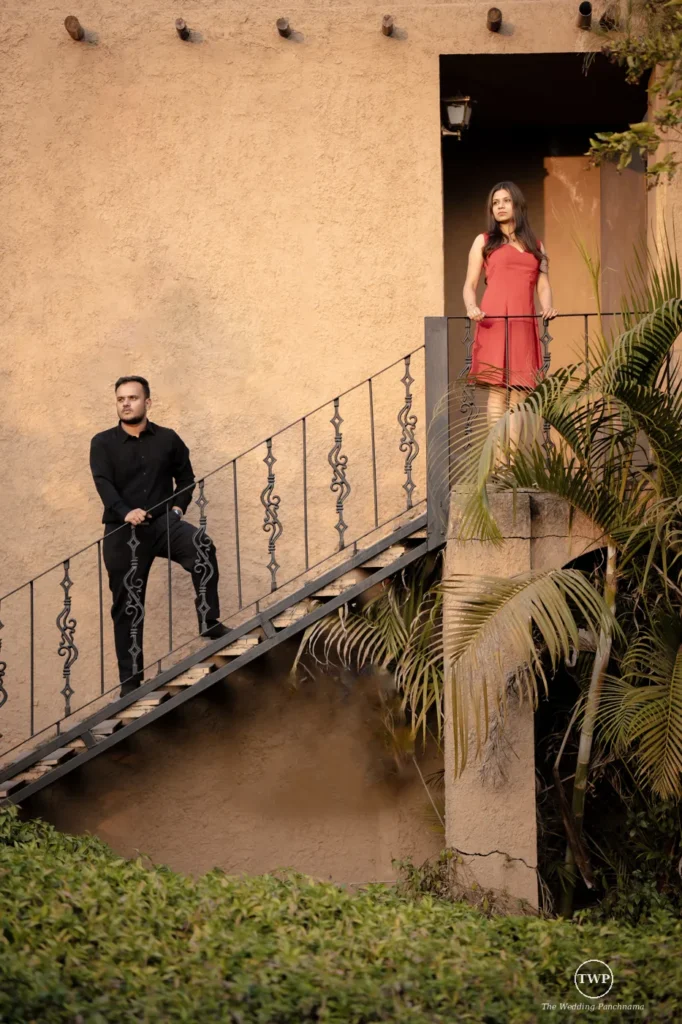 Couple standing on an ornate iron staircase during a couple shoot near Indore