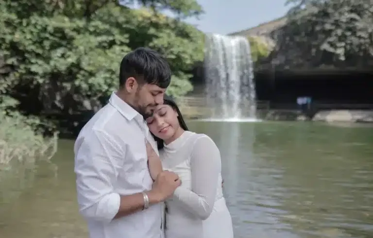 Couple embracing beside the waterfall at Ganga Mahadev