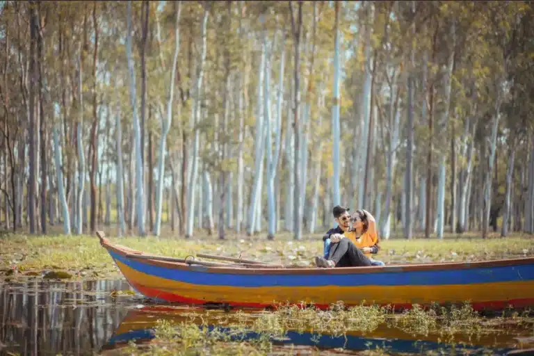 Couple in a colourful boat among trees at Lotus Valley, Gulawat