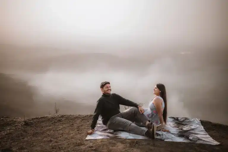 Couple seated on a misty hilltop near Jaam Gate, Mhow